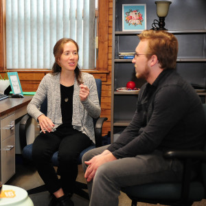 two students meeting with teacher